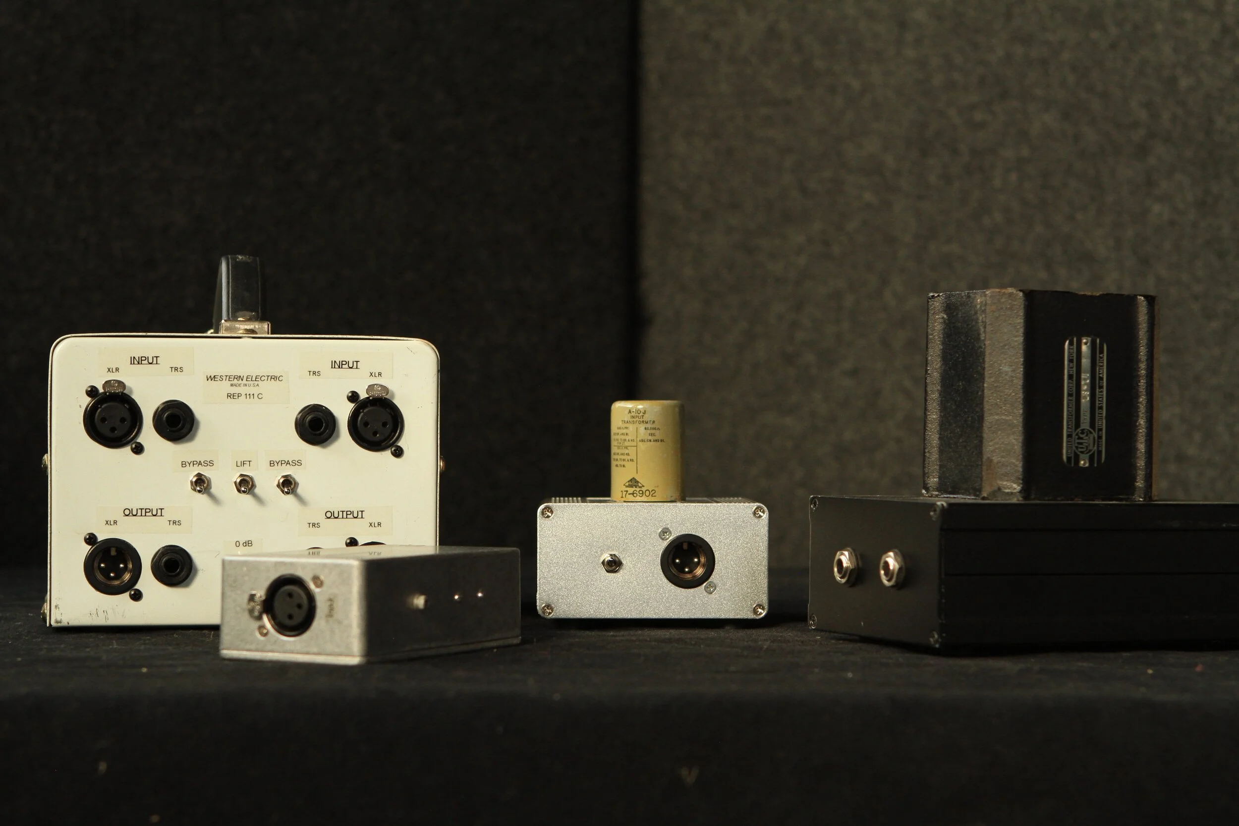  Several passive transformer boxes: a dual Western Electric 111C, a UTC O-10 Reamp, a Triad A10J, and a sandcast UTC LS-10. 